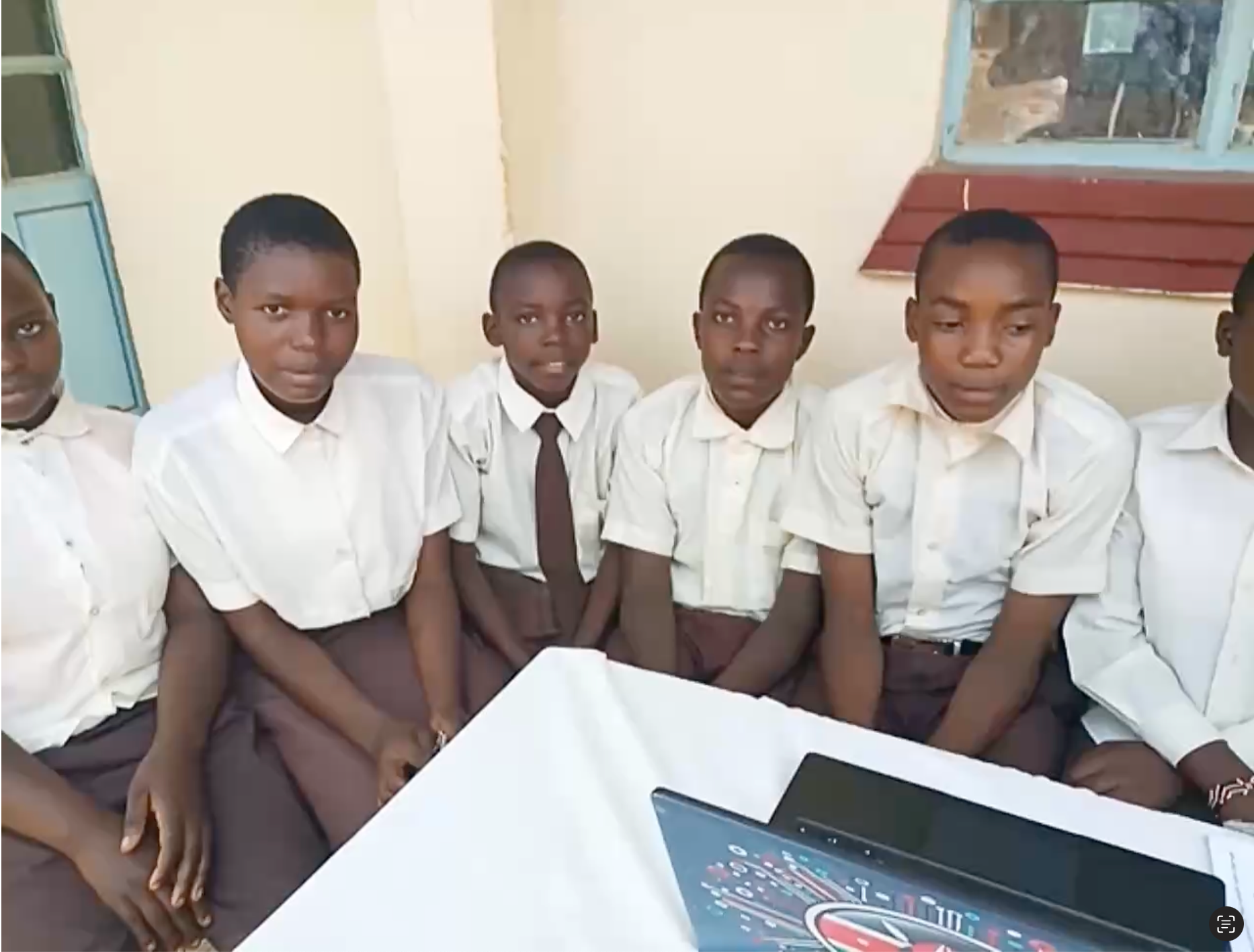 Kids sitting behind a laptop